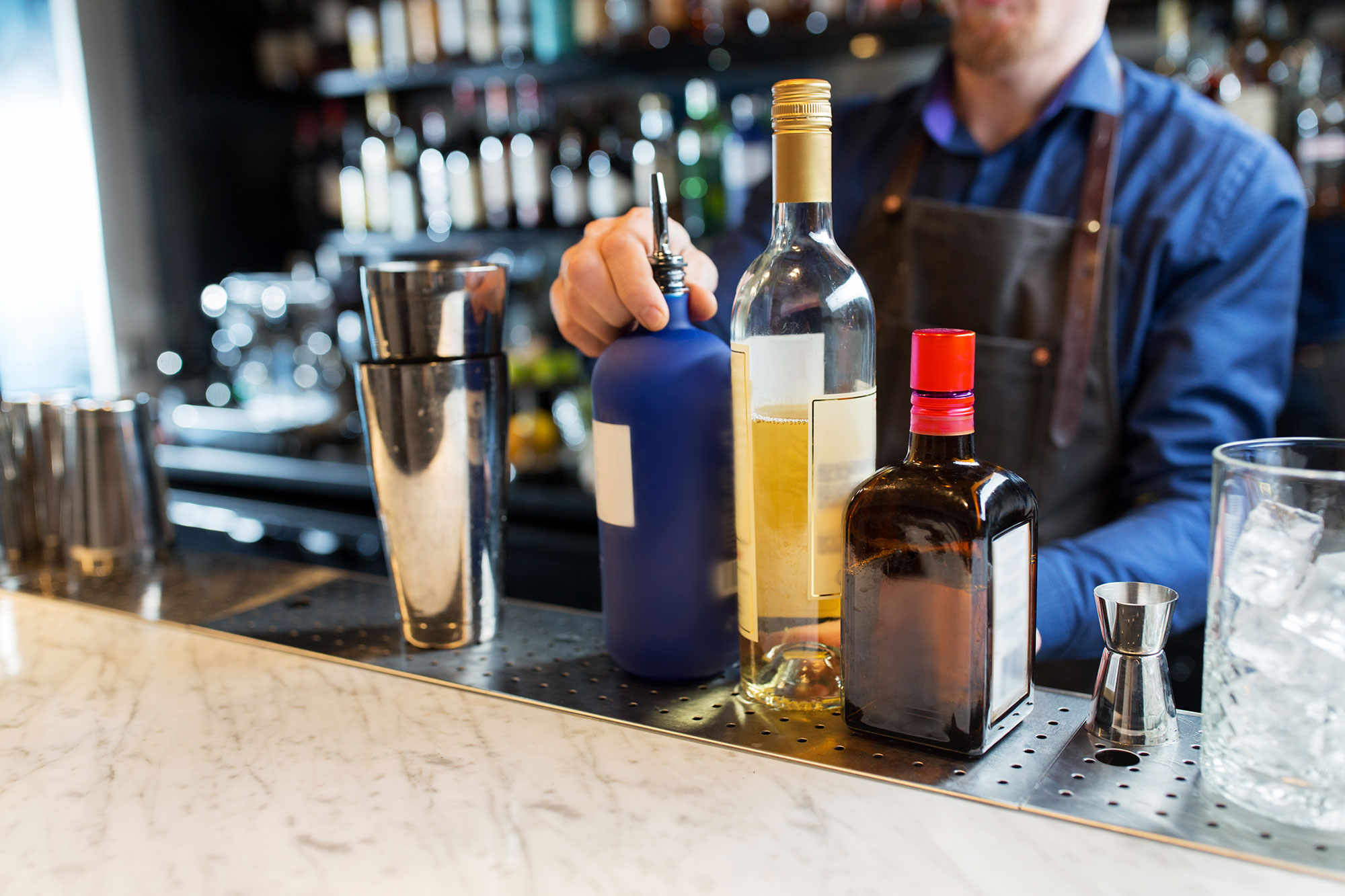 barman with shaker alcohol and jigger at bar PK8WBRZ edit